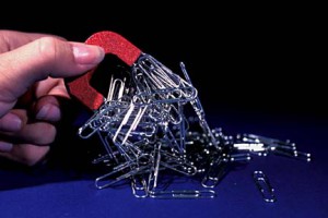 magnet holding up paperclips to illustrate magnetic content